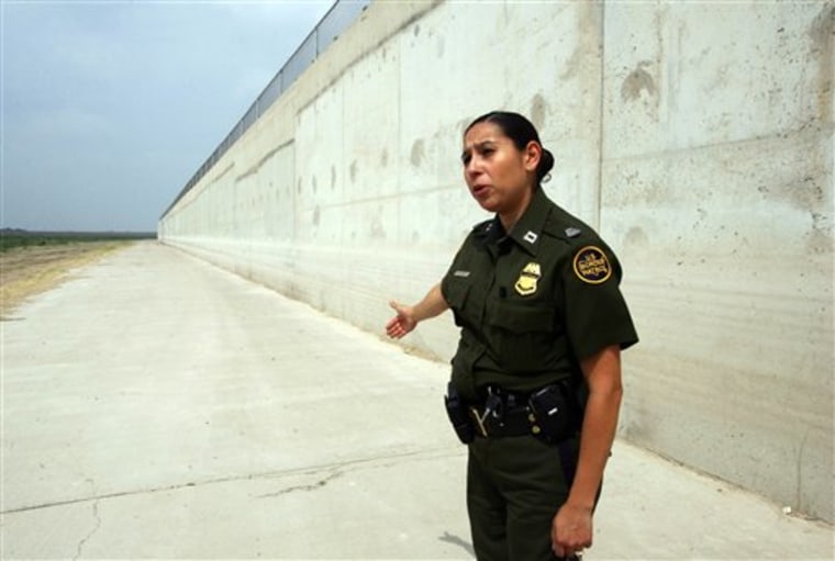 In this April 19, 2011 photo, U.S. Border Patrol agent Rosalinda Huey explains the border fence as part of the water levy that serves as a flood zone for the lower Rio Grande Valley south of Granjeno, Texas.   National Guard troops have augmented the Border Patrol's 21,000 agents by almost 6 percent since July, 2010. The troops serve as lookouts but are not directly involved in actual law enforcement activities. They are credited with helping arrest 17,000 illegal immigrants, almost 6 percent of those caught, according to Customs and Border Protection.(AP Photo/Delcia Lopez)